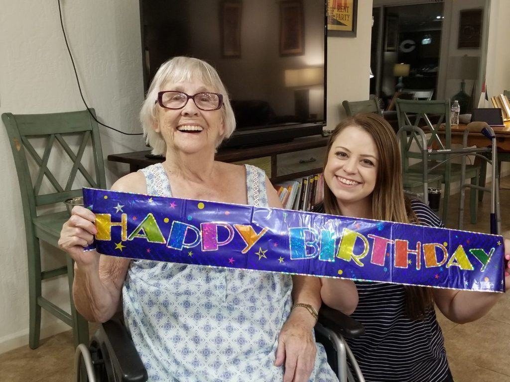 Grandma and Emily with a Happy Birthday sign